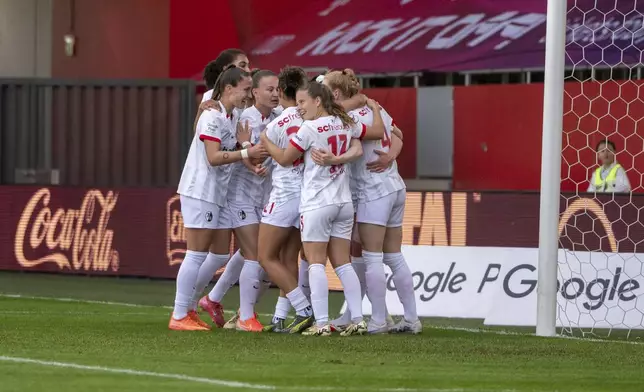 SC Freiburg players celebrate after scoring during a Women's Bundesliga soccer match against Bayern Munich in Munich, Germany, Sunday, April 27, 2025. (Leonie Asendorpf/dpa via AP)