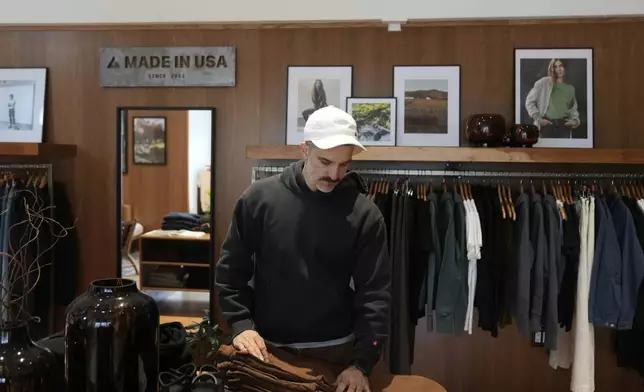 Javid Moghaddasnia, Director of Customer Engagement, discusses American Giant clothing while being interviewed at the company's showroom in San Francisco, Thursday, April 17, 2025. (AP Photo/Jeff Chiu)