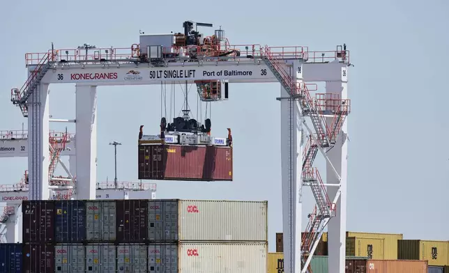 A crane lifts a container at the Port of Baltimore, Wednesday, April 9, 2025, in Baltimore. (AP Photo/Stephanie Scarbrough)