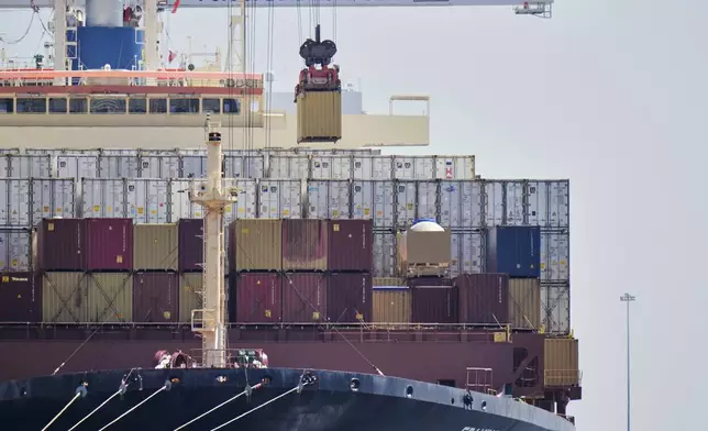A crane lifts a container from the cargo ship Epaminondas at the Port of Baltimore, Wednesday, April 9, 2025, in Baltimore. (AP Photo/Stephanie Scarbrough)