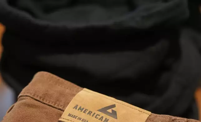 An American Giant logo tag is shown on pants at the company's showroom in San Francisco, Thursday, April 17, 2025. (AP Photo/Jeff Chiu)