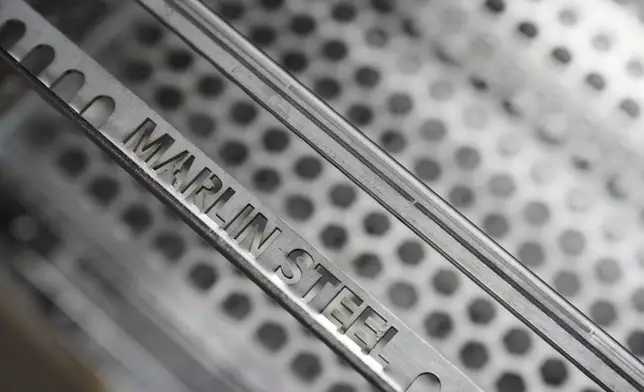 Name-plated steel pieces are seen at the Marlin Steel Wire manufacturing plant in Baltimore, Thursday, April 17, 2025. (AP Photo/Stephanie Scarbrough)