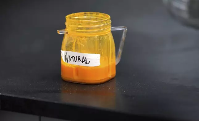 Natural food coloring is held in a jar in a lab at Sensient Technologies Corp., a color additive manufacturing company, in St. Louis., on Wednesday, April 2, 2025. (AP Photo/Jeff Roberson)