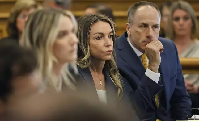 Karen Read, center, listens to testimony from witness Kerry Roberts during her trial in Norfolk Superior Court at Dedham, Mass., on Wednesday, April 23, 2025 (Greg Derr/The Patriot Ledger via AP, Pool)