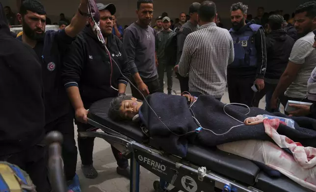 A Palestinians youth who was injured in an Israeli airstrike, is brought for a treatment at the Baptist Hospital in Gaza City on Wednesday, April 9, 2025. (AP Photo/Jehad Alshrafi)