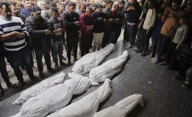 Mourners pray next to the bodies of Palestinians who were killed in an Israeli airstrike in Shijaiyah neighborhood, as they brought to the Baptist Hospital in Gaza City on Wednesday, April 9, 2025. (AP Photo/Jehad Alshrafi)
