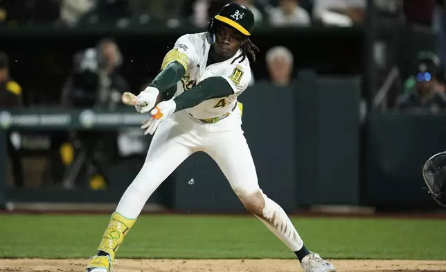 Athletics' Lawrence Butler hits an RBI single during the fourth inning of a baseball game against the San Diego Padres, Monday, April 7, 2025, in West Sacramento, Calif. (AP Photo/Godofredo A. Vásquez)