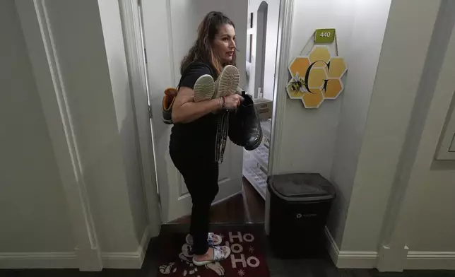 Shea Giagnorio packs belongings in her apartment days after getting fired from her job with the Administration for Children and Families, Monday, April 14, 2025, in Overland Park, Kan. (AP Photo/Charlie Riedel)