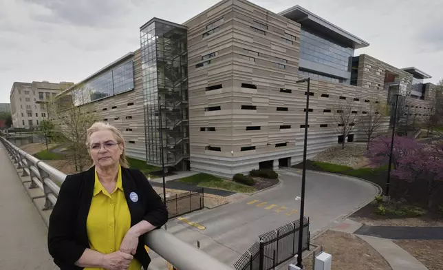 IRS customer service representative Shannon Ellis, stands outside a processing center where hundreds of her colleagues have taken buyouts and others face potential layoffs, Monday, April 14, 2025, in Kansas City, Mo. (AP Photo/Charlie Riedel)