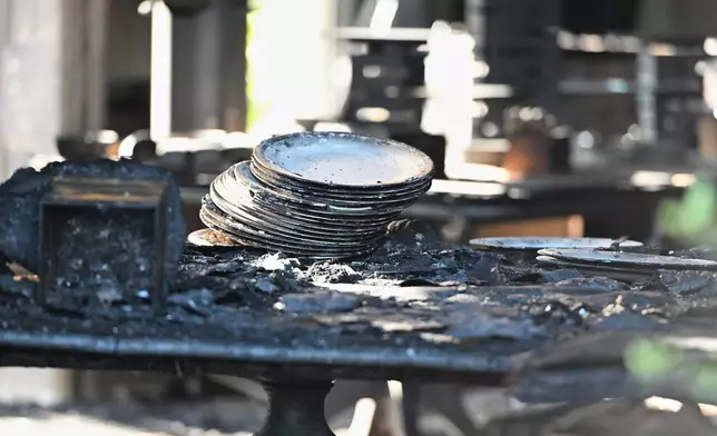Charred tables and dishes are visible inside the Pennsylvania governor's official residence after a man was arrested in an alleged arson that forced Gov. Shapiro, his family and guests to flee in the middle of the night on the Jewish holiday of Passover, Sunday, Apr. 13, 2025, in Harrisburg, Pa. (AP Photo/Marc Levy)