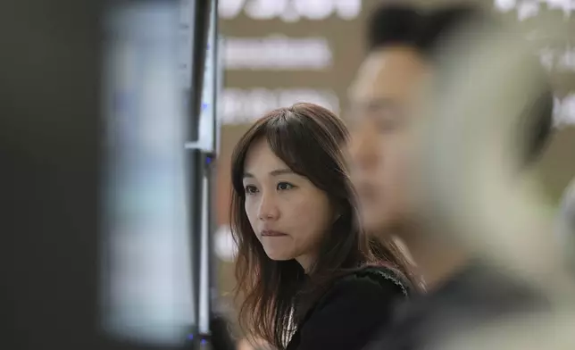 ADDS THE NAME OF THE BANK - Hana Bank employees watch computer monitors at a foreign exchange dealing room in Seoul, South Korea, Wednesday, April 16, 2025. (AP Photo/Lee Jin-man)