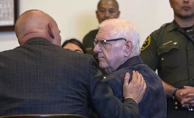 An Orange County Superior Court jury found Orange County Superior Court Judge Jeffrey Ferguson guilty of second-degree murder in the 2023 shooting death of his wife Sheryl Ferguson, is consoled by his attorney, Cameron Talley, after the verdict was read Tuesday, April 22, 2025, in Santa Ana, Calif. (Mindy Schauer/The Orange County Register via AP, Pool)