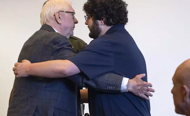 Orange County Superior Judge Jeffrey Ferguson, left, who was found guilty of second-degree murder in the shooting death of his wife Sheryl Ferguson in 2023, embraces his son, Phillip Ferguson, before being led away in handcuffs on Tuesday, April 22, 2025, in Santa Ana, Calif. (Mindy Schauer/The Orange County Register via AP, Pool)