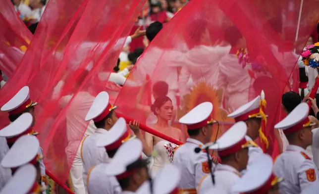Vietnamese dancers perform during a parade celebrating the 50th anniversary of the end of the Vietnam War in Ho Chi Minh City, Vietnam, Wednesday, April 30, 2025. (AP Photo/Achmad Ibrahim)