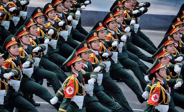 A Vietnamese women's medical unit marches during a military parade celebrating the 50th anniversary of the end of the Vietnam War on Wednesday, April 30, 2025, in Ho Chi Minh City, Vietnam. (AP Photo/Richard Vogel)
