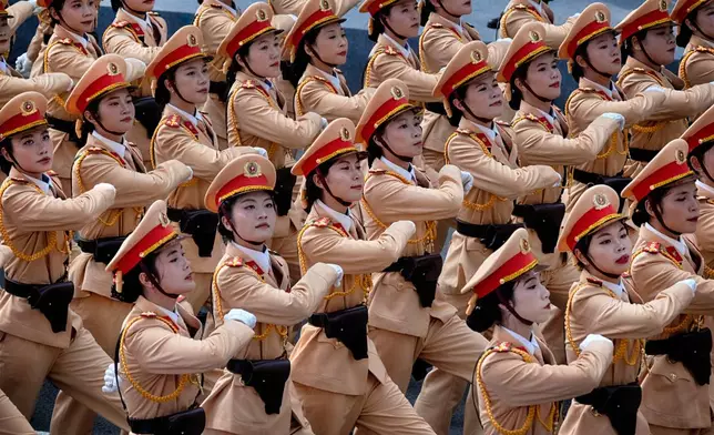 Vietnamese female police officers march during a parade celebrating the 50th anniversary of the end of the Vietnam War on Wednesday, April 30, 2025, in Ho Chi Minh City, Vietnam. (AP Photo/Richard Vogel)