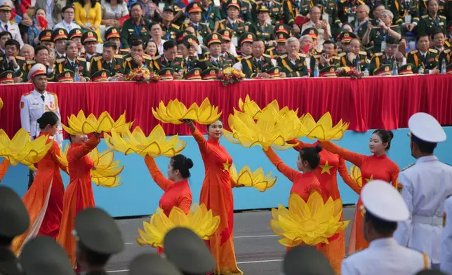 Vietnamese dancers perform during a parade celebrating the 50th anniversary of the end of the Vietnam War in Ho Chi Minh City, Vietnam, Wednesday, April 30, 2025. (AP Photo/Achmad Ibrahim)
