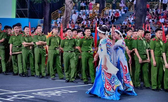Vietnamese participants gather prior to a parade during the 50th anniversary celebration of the end of the Vietnam War on Wednesday, April 30, 2025, in Ho Chi Minh City, Vietnam. (AP Photo/Richard Vogel)