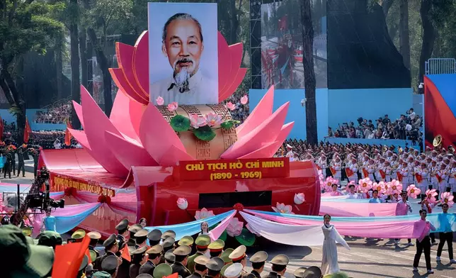 A float carrying a portrait of the late Vietnamese revolutionary leader Ho Chi Minh takes part in a parade during the 50th anniversary celebration of the end of the Vietnam War Wednesday, April 30, 2025, in Ho Chi Minh City, Vietnam. (AP Photo/Richard Vogel)