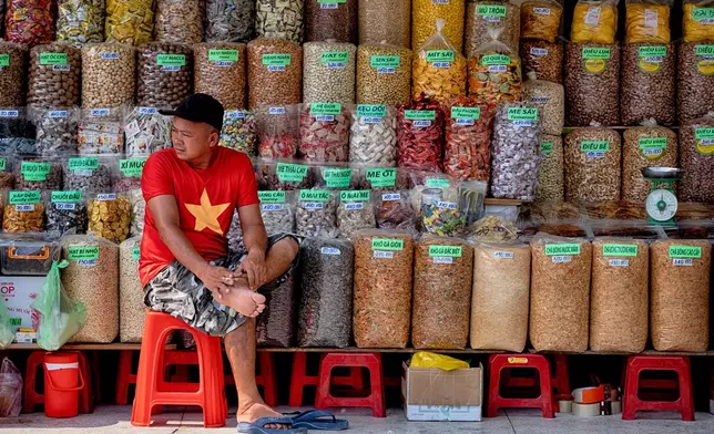 A spice vendor waits for customers at the Cholon market in the Cholon district of Ho Chi Minh City, Vietnam, on Tuesday, April 29, 2025 ahead of the 50th anniversary of the end of the Vietnamese War. (AP Photo/Richard Vogel)