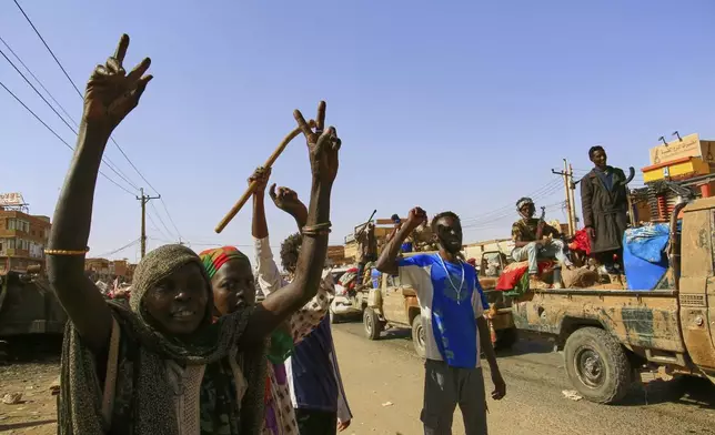 FILE - Local residents cheer as soldiers arrive to the Allafah market, in an area recently recaptured by Sudan's army from the Rapid Support Forces paramilitary group, in the Al Kalalah district, south of Khartoum, Sudan, March 27, 2025. (AP Photo, File)