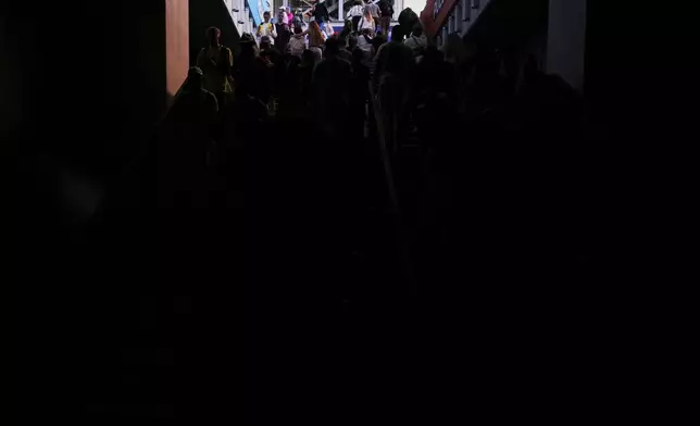 Spectators walk out of the Madrid Open tennis tournament venue during a general blackout in Madrid, Monday, April 28, 2025. (AP Photo/Manu Fernandez)