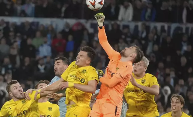 FILE - Glimt's goalkeeper Nikita Haikin punches the ball during the Europe League quarter final second leg match between Lazio and Bodo Glimt in Rome, Italy, Thursday, April 17, 2025. (AP Photo/Alessandra Tarantino, File)