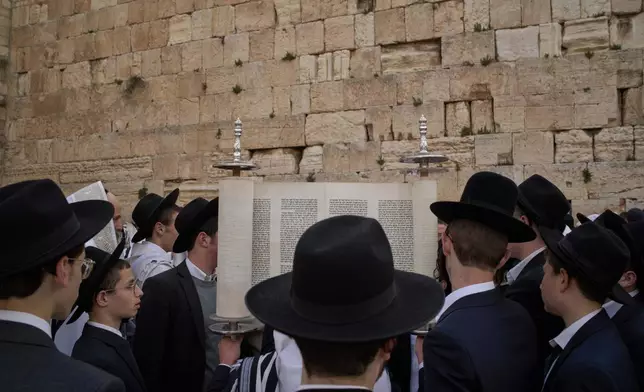 Ultra-Orthodox Jewish men participate in a blessing during the holiday of Passover, at the Western Wall, the holiest site where Jews can pray, in the Old City of Jerusalem, Tuesday, April 15, 2025. (AP Photo/Leo Correa)