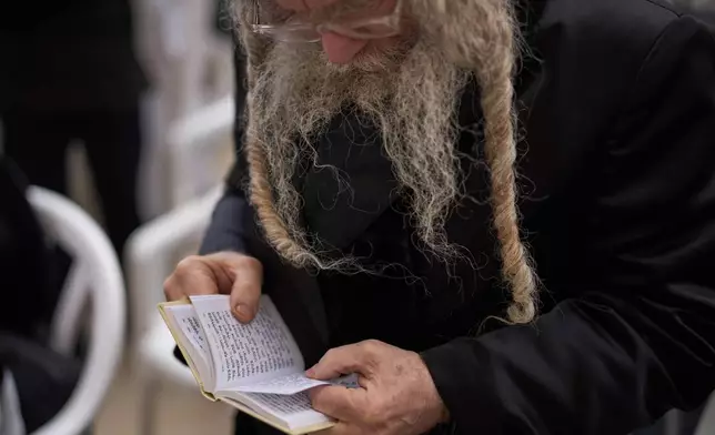 An ultra-Orthodox Jew participates in a blessing during the holiday of Passover, at the Western Wall, the holiest site where Jews can pray, in the Old City of Jerusalem, Tuesday, April 15, 2025. (AP Photo/Leo Correa)