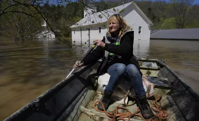 Wanona Harp paddles past inundated churches in Lockport, Ky., flooded by the Kentucky River, April 8, 2025. (AP Photo/Carolyn Kaster)
