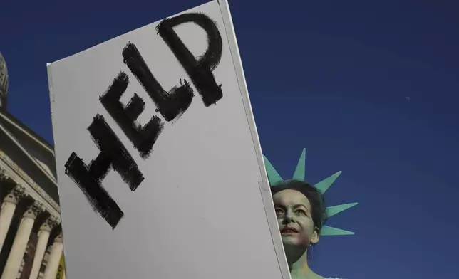 Helena Jensen joins a "Hands Off!" demonstration against President Donald Trump and Elon Musk, at Trafalgar Square in London, April 5, 2025. (AP Photo/Kin Cheung)