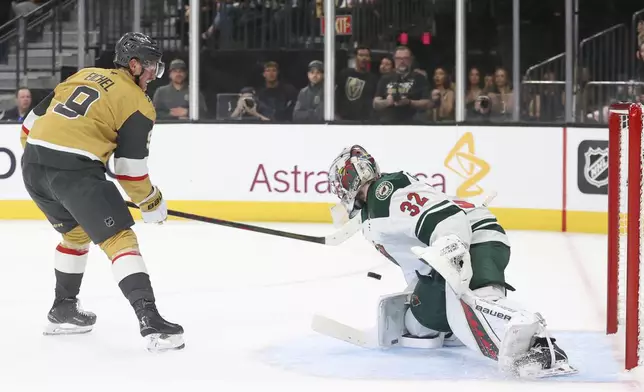 Minnesota Wild goaltender Filip Gustavsson (32) stops a shot from Vegas Golden Knights center Jack Eichel (9) during the second period in Game 1 of an NHL hockey Stanley Cup first-round playoff series Sunday, April 20, 2025, in Las Vegas. (AP Photo/Ian Maule)