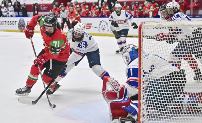 From left, Fruzsina Mayer of Hungary, Emilie Kruse of Norway and goalkeeper Ena Nyström of Norway in action during the IIHF Women's World Championship, Group B, match between Hungary and Norway, in Ceske Budejovice, Czech Republic, Sunday, April 13, 2025. (Václav Pancer/CTK via AP)