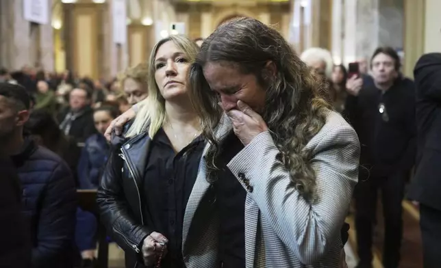 A worshipper cries during Mass at the Cathedral in Buenos Aires, Argentina, following the Vatican's announcement of Pope Francis' death, Monday, April 21, 2025. (AP Photo/Natacha Pisarenko)