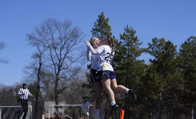 University of Wisconsin - Stout players celebrate during a women's college flag football game against University of Northwestern St. Paul, April 7, 2025, in St. Paul. Minn. (AP Photo/Abbie Parr)