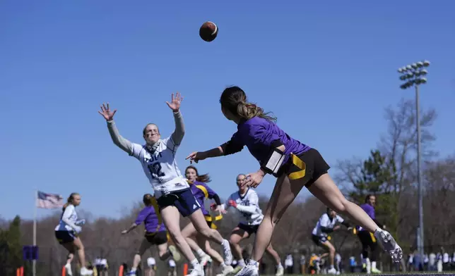 University of Northwestern St. Paul and University of Wisconsin - Stout players compete during a women's college flag football game, April 7, 2025, in St. Paul. Minn. (AP Photo/Abbie Parr)