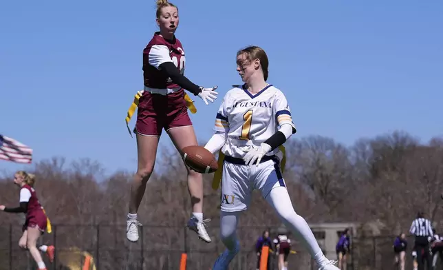 Augustana University and Concordia University, St. Paul players compete during a women's college flag football game, April 7, 2025, in St. Paul. Minn. (AP Photo/Abbie Parr)