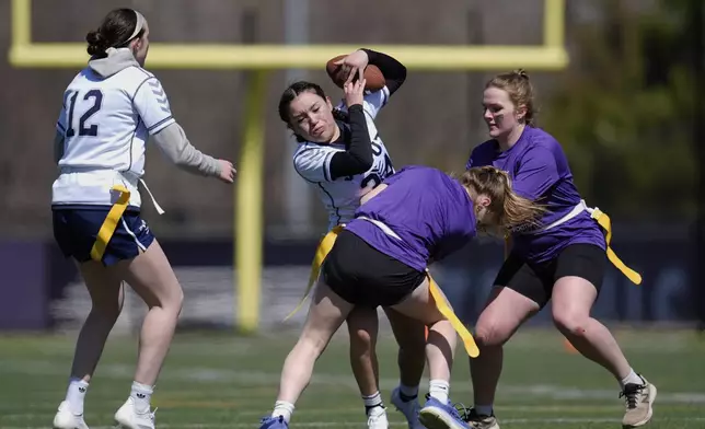 University of Northwestern St. Paul and University of Wisconsin - Stout players compete during a women's college flag football game, April 7, 2025, in St. Paul. Minn. (AP Photo/Abbie Parr)