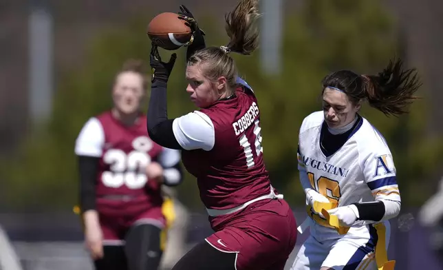 Augustana University and Concordia University, St. Paul players compete during a women's college flag football game, April 7, 2025, in St. Paul. Minn. (AP Photo/Abbie Parr)