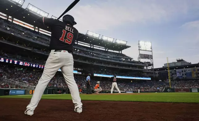 Washington Nationals' Josh Bell (19) times his swing while on deck as Keibert Ruiz (20) is at bat during the fourth inning of a baseball game against the Baltimore Orioles, Wednesday, April 23, 2025, in Washington. (AP Photo/Stephanie Scarbrough)