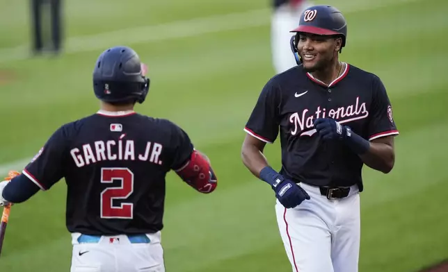Washington Nationals' James Wood, right, celebrates with Luis Garcia Jr. (2) after hitting a home run during the first inning of a baseball game against the Baltimore Orioles, Wednesday, April 23, 2025, in Washington. (AP Photo/Stephanie Scarbrough)