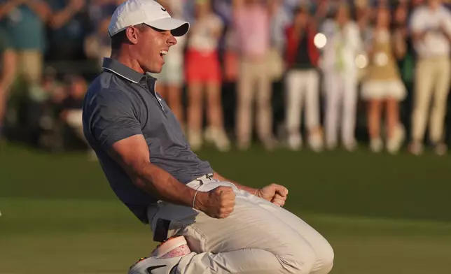 Rory McIlroy, of Northern Ireland, celebrates winning in a playoff against Justin Rose, of England, after the final round the Masters golf tournament, Sunday, April 13, 2025, in Augusta, Ga. (AP Photo/Matt Slocum)