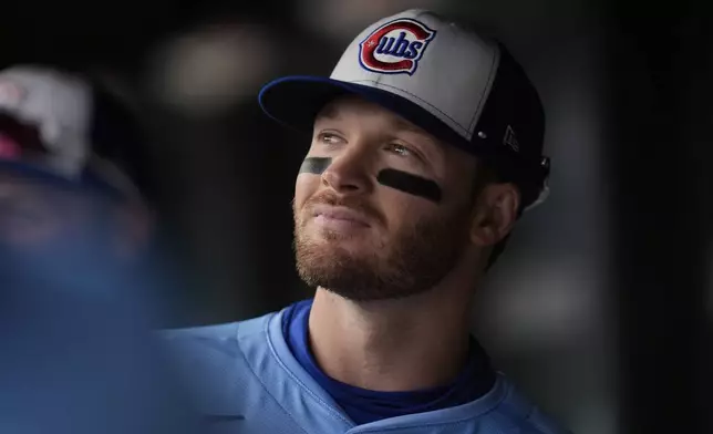 Chicago Cubs' Ian Happ (8) stands in the dugout during the first inning of a baseball game against the San Diego Padres, Saturday, April 5, 2025, in Chicago. (AP Photo/Erin Hooley)