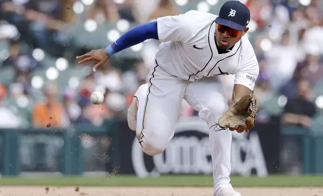 Detroit Tigers third baseman Andy Ibáñez fields a grounder hit by San Diego Padres' Mason Macoy before throwing him out at first base during the ninth inning of a baseball game Wednesday, April 23, 2025, in Detroit. (AP Photo/Duane Burleson)