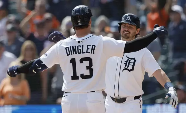 Detroit Tigers' Dillon Dingler (13) is greeted by Zach McKinstry, right, after hitting a 2-run home run during the eighth inning of a baseball game against the San Diego Padres, Wednesday, April 23, 2025, in Detroit. (AP Photo/Duane Burleson)