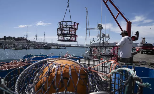 Pop-up gear, meant to prevent whale entanglements while crab fishing, front, sits on Pier 45 as James Sanders loads crab traps onto the boat Pale Horse in San Francisco, Thursday, April 10, 2025. (AP Photo/Emily Steinberger)