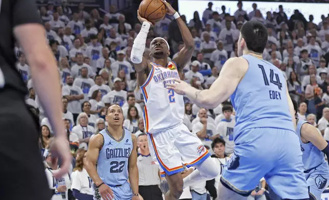 Oklahoma City Thunder guard Shai Gilgeous-Alexander (2) looks to shoot between Memphis Grizzlies guard Desmond Bane (22) and center Zach Edey (14) during the first half in Game 1 of an NBA first-round playoff series, Sunday, April 20, 2025, in Oklahoma City. (AP Photo/Nate Billings)