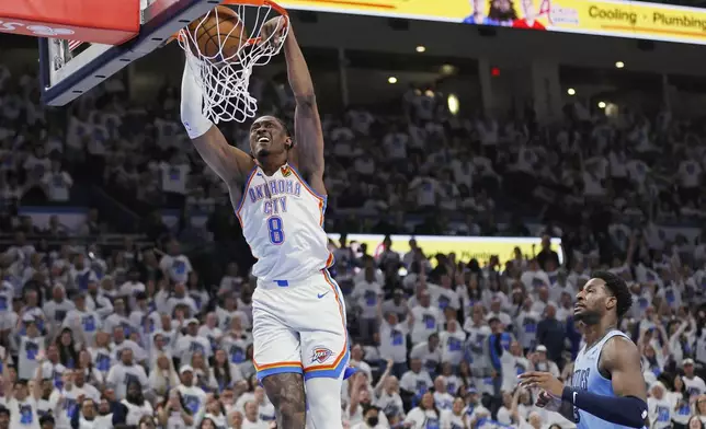 Oklahoma City Thunder forward Jalen Williams (8) dunks as Memphis Grizzlies forward Jaren Jackson Jr., right, looks on during the first half in Game 1 of an NBA first-round playoff series, Sunday, April 20, 2025, in Oklahoma City. (AP Photo/Nate Billings)
