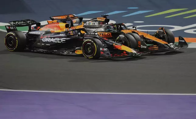 Red Bull driver Max Verstappen of the Netherlands, front, steers his car followed by McLaren driver Oscar Piastri of Australia during the Formula One Saudi Arabian Grand Prix at the Jeddah Corniche Circuit in Jeddah, Saudi Arabia, Sunday, April 20, 2025. (AP Photo/Darko Bandic)