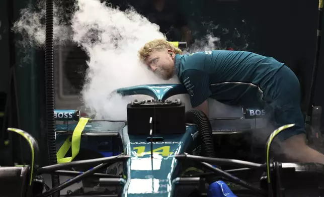 A mechanic works on the Aston Martin driver Fernando Alonso's car during the qualifying session ahead of the Formula One Saudi Arabian Grand Prix at the Jeddah Corniche Circuit in Jeddah, Saudi Arabia, Saturday, April 19, 2025. (Thaier Al-Sudani/Pool Via AP)